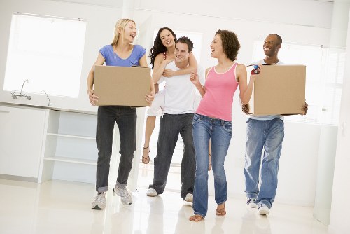 Removal team carrying items through a residential property in Customhouse