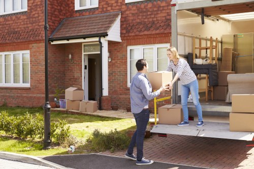 Professional movers loading boxes and furniture for a house move in Customhouse