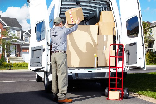 Local moving van helping customers with furniture and boxes in Customhouse