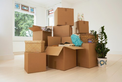 Careful loading of household items into a van in Customhouse