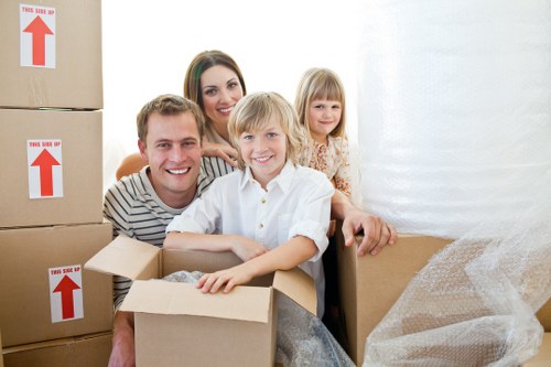 Movers carrying furniture from a flat in Customhouse