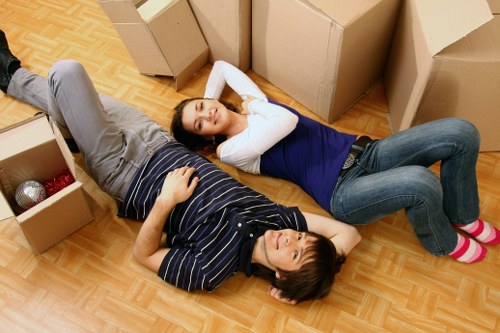 Loading household items into a van for a Customhouse move